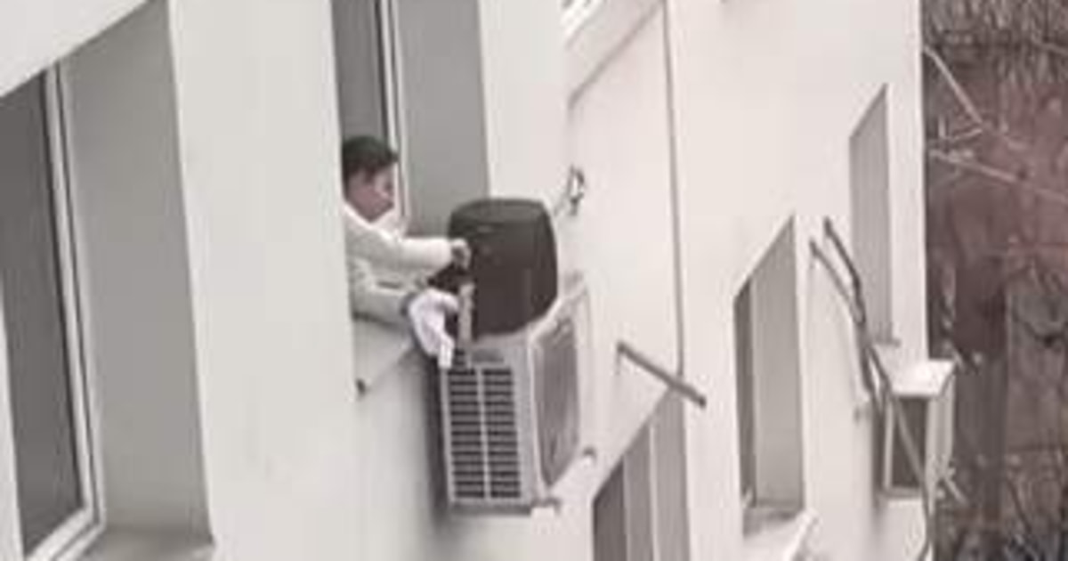 O femeie, filmată gătind la airfryer pe geam, sprijinit pe unitatea de aer condiționat: clipul viral a stârnit reacții